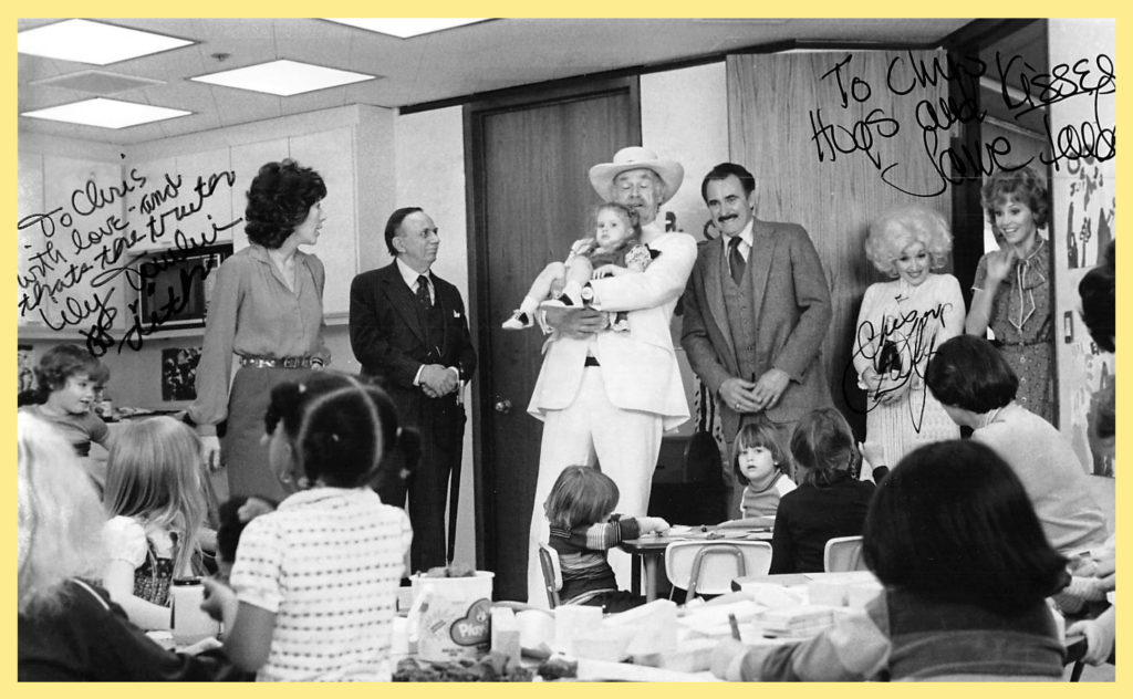 9 to 5 Daycare Scene - Jenny being held, CD to the far left