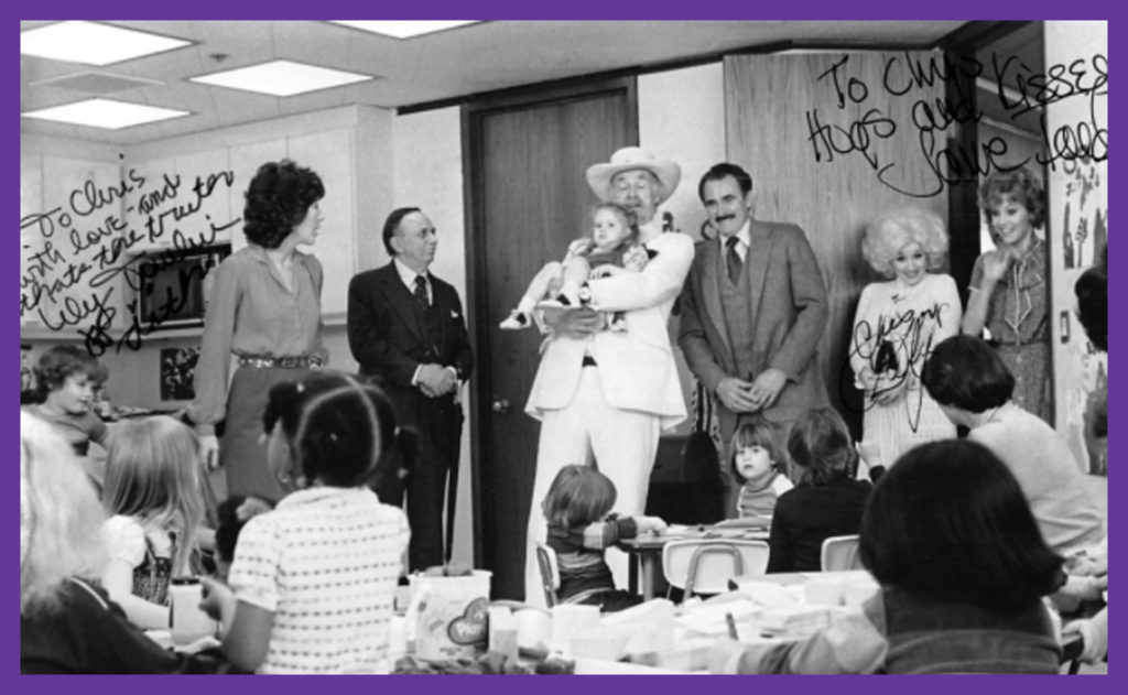 9 to 5 Daycare Scene - Jenny being held, CD to the far left